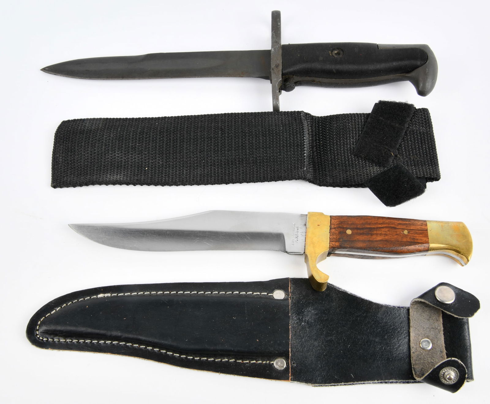 A Pair of Fixed-Blade Knives, Comprising a Military-Style Bayonet and a Bowie-Style Hunting Knife: A pair of fixed-blade knives, comprising a military-style bayonet and a Bowie-style hunting knife. The military-style bayonet features a darkened metal blade, a straight crossguard, and a black ribbed