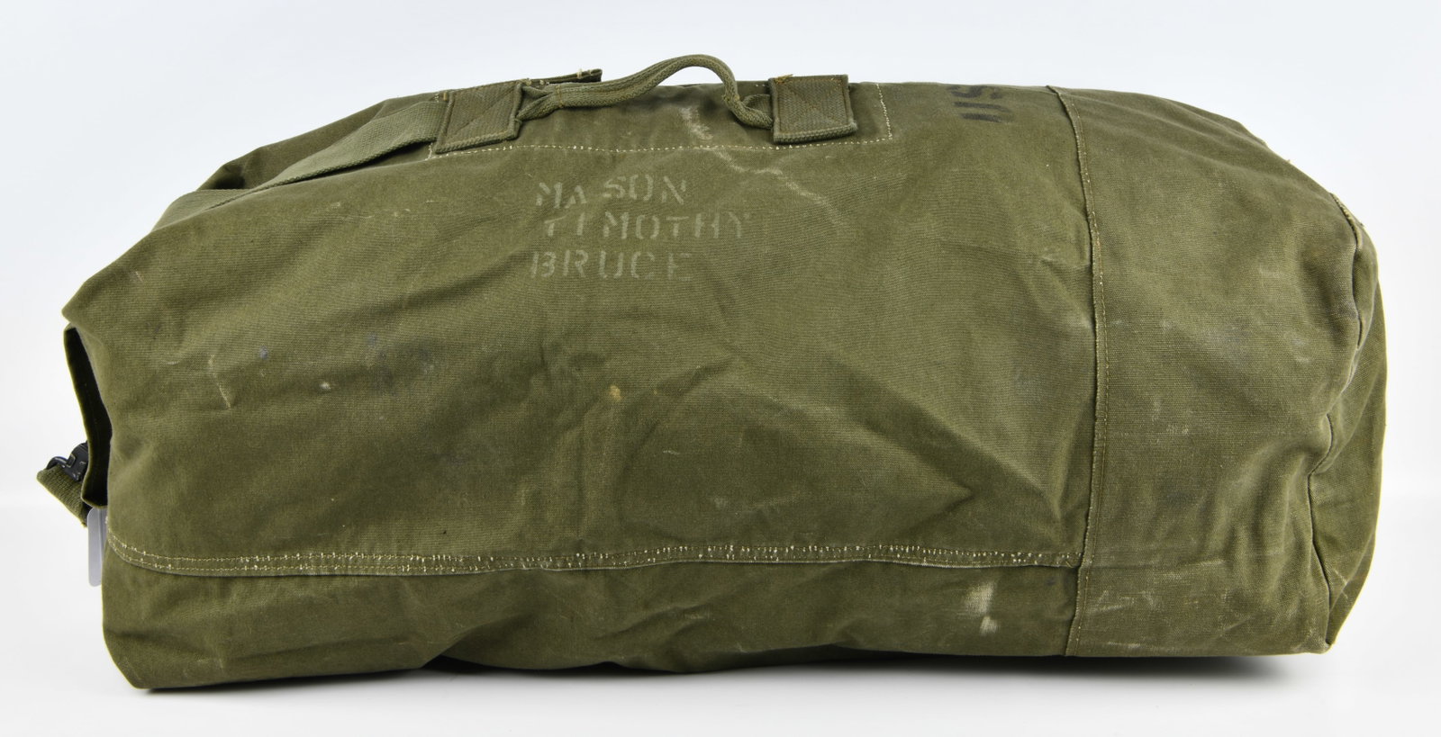 United States Military M-7 Type II Duffel Bag, dated 1971: A United States Military M-7 Type II Duffel Bag, dated 1971. This olive drab military-style duffel bag is constructed from heavy canvas material and features a single woven carry handle. Stenciled in 