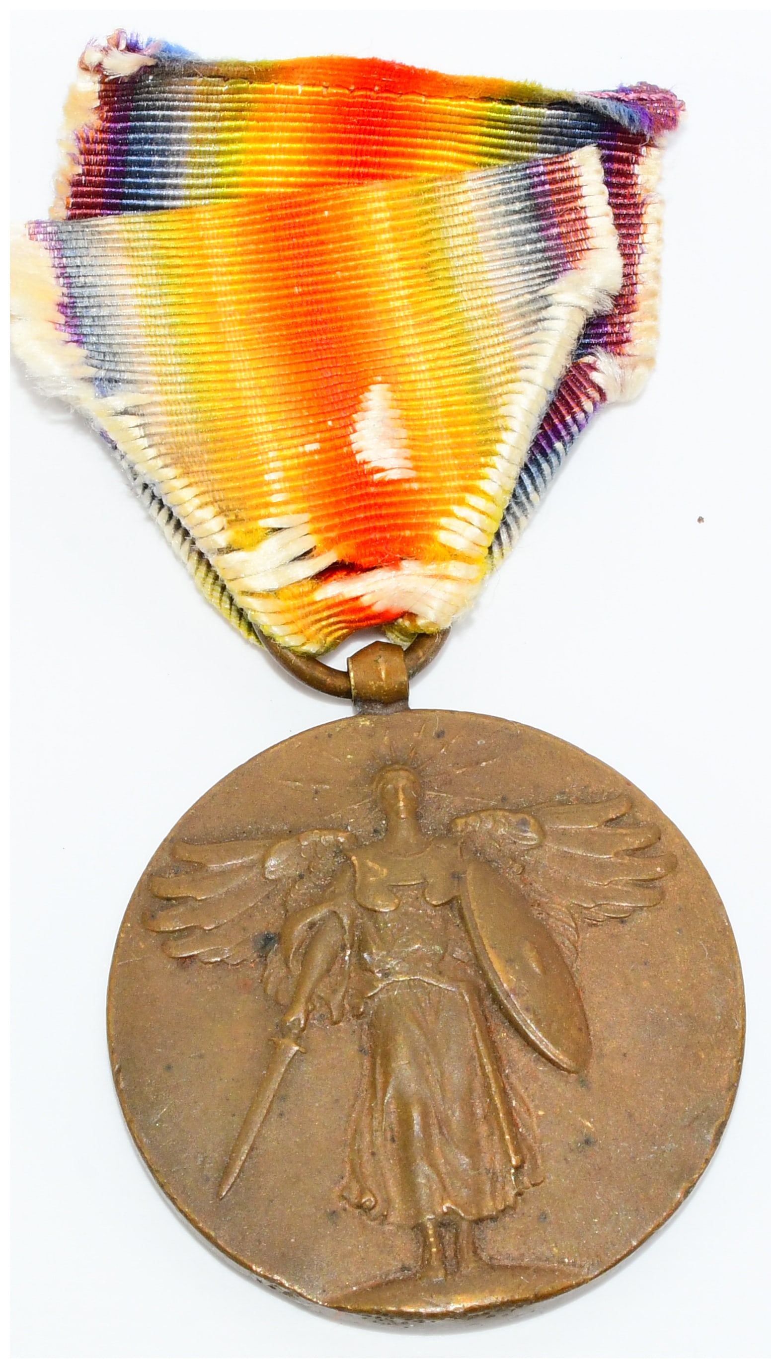 United States World War I Victory Medal with Rainbow Ribbon: A United States World War I Victory Medal, dating to the early 20th century. This circular, bronze-toned commemorative medal is suspended from a folded textile ribbon displaying a rainbow spectrum of 