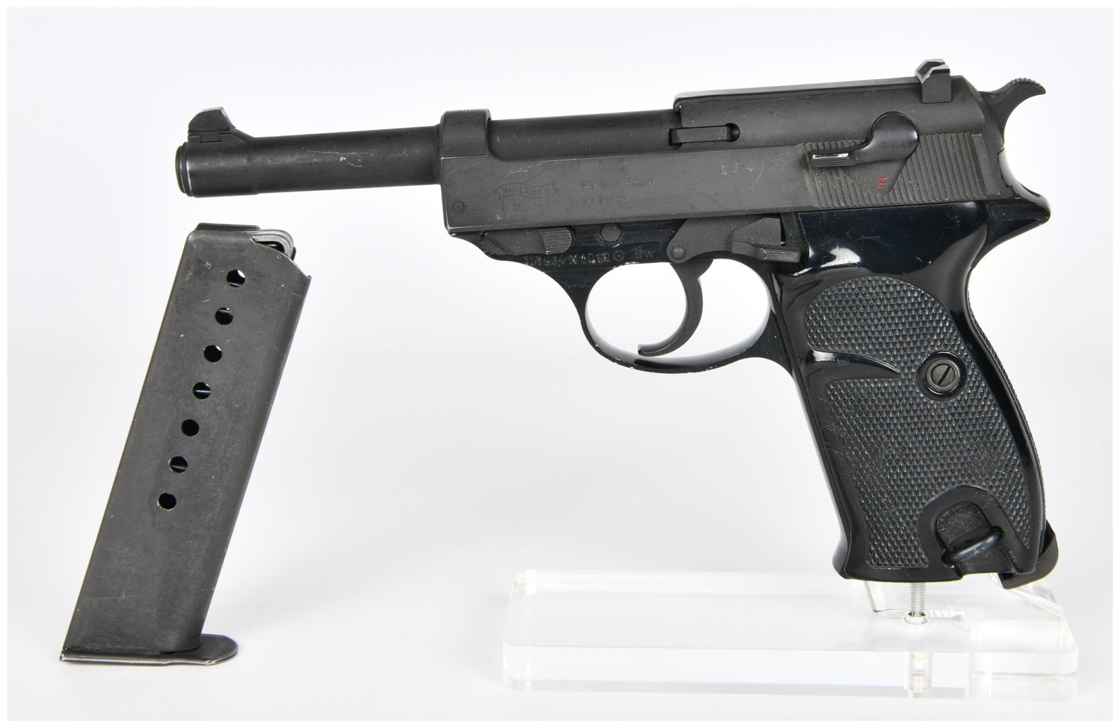 Walther P1 (P.38) 9mm Semi-Automatic Pistol, Dated 4/79: A Walther P1 (P.38) 9mm semi-automatic pistol, dated 4/79. The pistol is constructed predominantly of blued metal with dark, textured plastic grip panels. The left side of the slide is clearly marked 