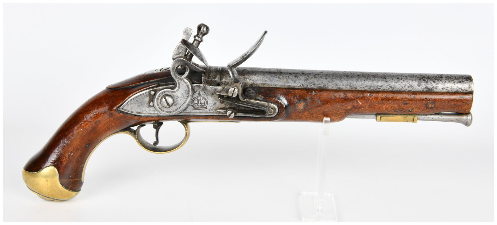 A British Light Dragoon Flintlock Pistol: An antique British Light Dragoon Flintlock Pistol, constructed with a polished dark wood stock, an iron or steel barrel, and brass furniture. The lock plate is visibly marked with a crown symbol above