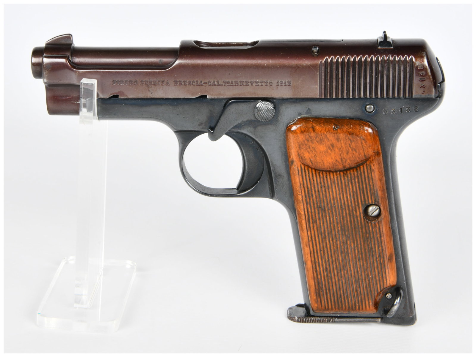 Beretta Model 1915 Semi-Automatic Pistol, Caliber 7.65, Serial No. 63138: A Beretta Model 1915 semi-automatic pistol, an early 20th-century service or military model. The pistol is constructed from blued steel with brown checkered wooden grip panels. The slide is clearly ma