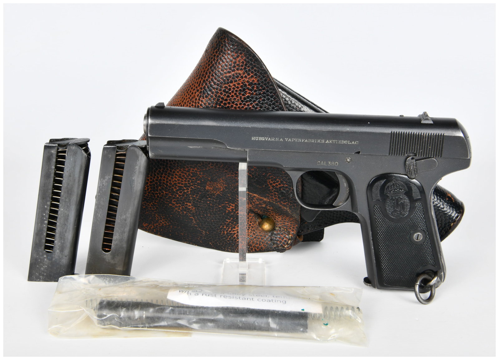 A Swedish Husqvarna Model 1907 Semi-Automatic Pistol Rig: A Swedish Husqvarna Model 1907 Semi-Automatic Pistol Rig. The pistol, manufactured by Husqvarna Vapenfabriks Aktiebolag, is chambered in CAL.380 and features a blued metal finish. It is fitted with te