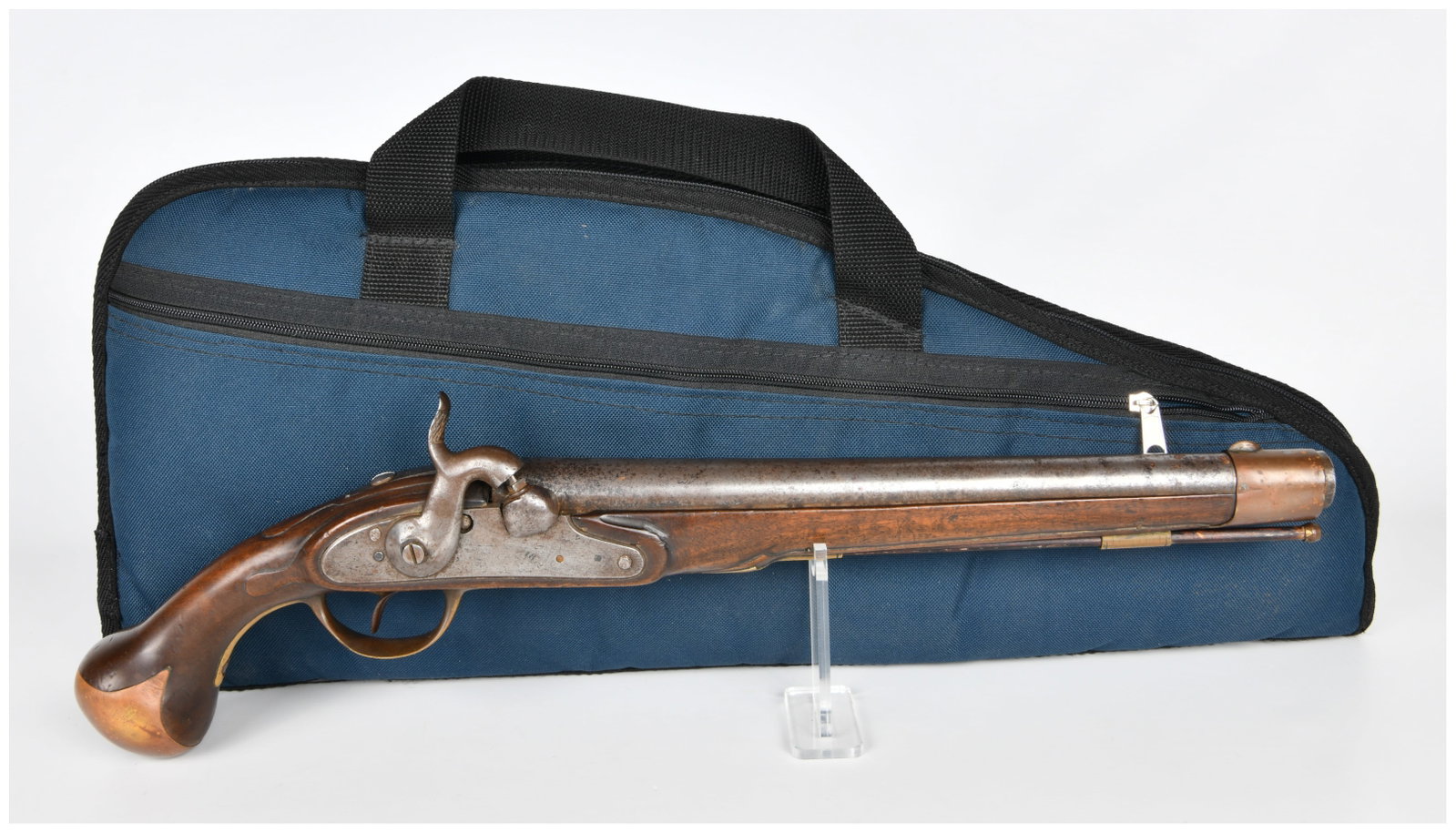 Mid-19th Century Single-Shot Percussion Cap Pistol: A single-shot percussion cap pistol, likely dating to the mid-19th century. The pistol features a dark wooden full stock with a 'bag' grip and a metal barrel, lock plate, and hammer. The barrel and lo