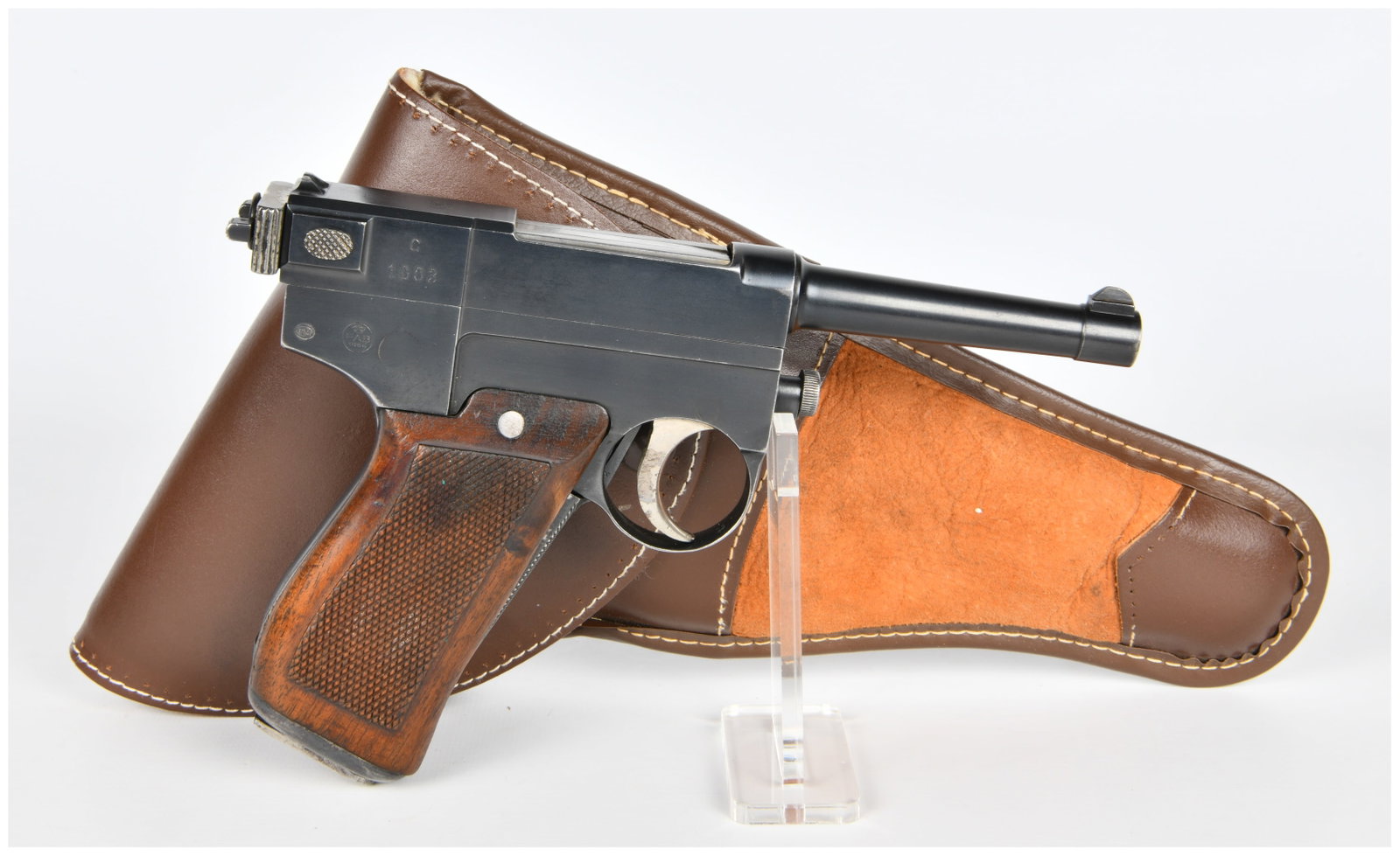Italian Glisenti Model 1910 Semi-Automatic Pistol with Holster: An Italian Glisenti Model 1910 semi-automatic pistol, presented with a fitted brown leather holster. Constructed from blued steel, the pistol features finely checkered dark wooden grip panels and a br