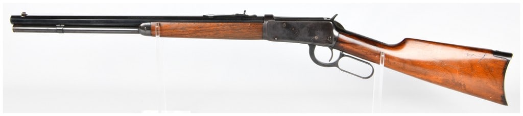 Win Model 94 Lever-Action Repeating Rifle .30 W.C.F. Dated 1923 20" Barrel: A Winchester Model 94 lever-action repeating rifle, dated 1923, featuring a 20" barrel. Constructed from blued steel and dark-grained hardwood for the stock and forend. Visible markings on the barrel 