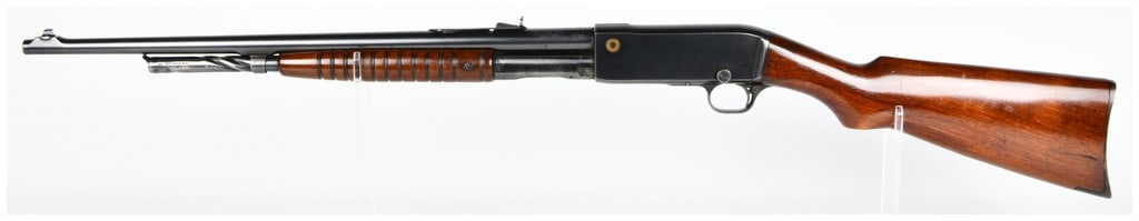 Rem Model 14 Pump-Action Sporting Rifle .35 REM. 22" Barrel: A pump-action sporting rifle, primarily constructed from blued steel and featuring a dark, polished wooden stock and a ribbed wooden forend. The rifle is equipped with a 22" barrel. Visible markings o