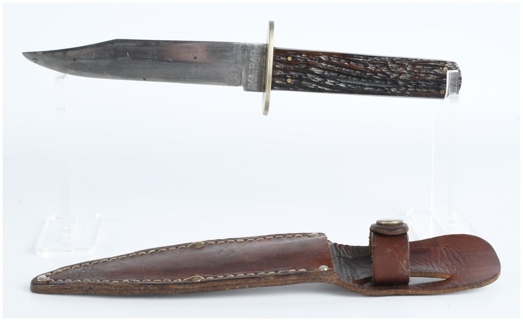 KA-BAR Union Cutlery Co. Olean N.Y. Fixed-Blade Bowie-Style Knife with Sheath: This lot comprises a fixed-blade knife manufactured by Union Cutlery Co., Olean, N.Y., under their KA-BAR brand. The ricasso is stamped 'KA-BAR' on one side and 'UNION CUTLERY CO. OLEAN, N.Y.' on the 