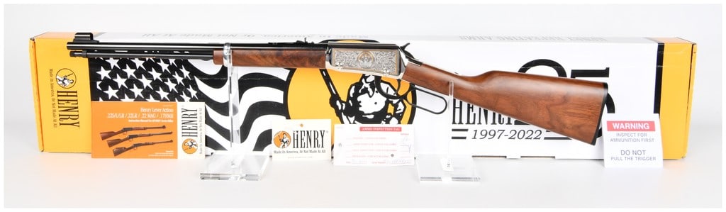 Henry H001-25 Lever Action .22 S/L/LR 25th Anniversary Edition Rifle: A Henry Repeating Arms H001-25 Lever Action .22 S/L/LR 25th Anniversary Edition rifle. The rifle features a blued metal barrel and magazine tube, with rich dark wood furniture for the stock and forend