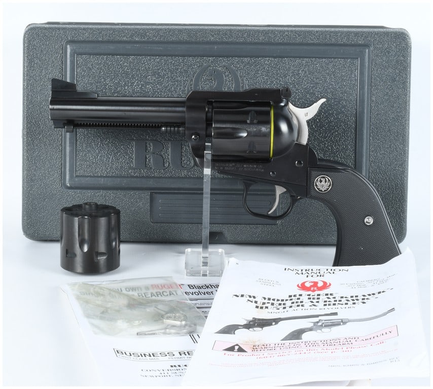 Ruger New Model Blackhawk Convertible SA Revolver .357 Mag / 9mm: A Ruger New Model Blackhawk Convertible single-action revolver, chambered in .357 Magnum and accompanied by an interchangeable 9mm cylinder. The firearm features a blued steel finish on the barrel, fr