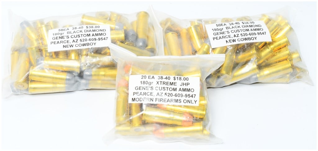 120 Rounds of Gene's Custom .38-40 Ammo including Black Diamond Cowboy and Xtreme JHP: This lot comprises 120 rounds of .38-40 caliber ammunition, presented in four clear plastic bags. Three of these bags are labeled "50EA 38-40 $38.00 180gr BLACK DIAMOND GENE'S CUSTOM AMMO PEARCE, AZ 5