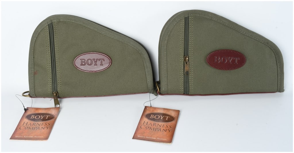 Pair of Boyt Harness Company Heart Shaped Handgun Cases Olive Green: A pair of Boyt Harness Company Heart Shaped Handgun Cases. These two identical, modern, olive green canvas padded cases are designed for firearms. Each case features a triangular profile with a rounde