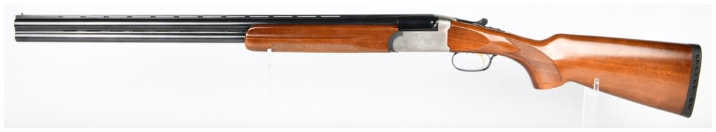 American Arms Inc. Silver 12 12 Gauge Over/Under Shotgun 28" Barrel: An American Arms Inc. Silver 12 12 Gauge Over/Under Shotgun, featuring 28" blued steel barrels and a polished silver-toned steel receiver adorned with intricate scroll engraving. The shotgun is fitted