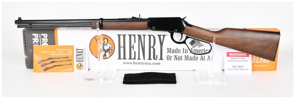Henry Repeating Arms Model H001TML Lever Action Rifle .22 WMR Octagonal Barrel Large Loop: A Henry Repeating Arms Model H001TML lever-action rifle, chambered in .22 WMR (.22 Magnum). This rifle features a blued steel receiver, an octagonal barrel, and a reddish-brown wood stock and forearm.