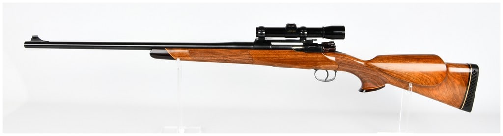 Mauser Custom Safari .458X2 Bolt Action with Leupold Scope: Mauser Custom Safari Bolt Action rifle chambered in .458 X2. The rifle features a custom-style, highly figured polished wooden stock, likely walnut, with a distinct Monte Carlo comb, pistol grip, cont