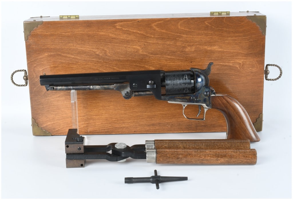 Lyman .36 Cal Navy Model Black Powder Percussion Revolver Cased: A Lyman .36 caliber black powder percussion revolver, styled as a 19th-century "Navy Model," presented in a fitted wooden case with accessories. The revolver features a blued octagonal barrel inscribe