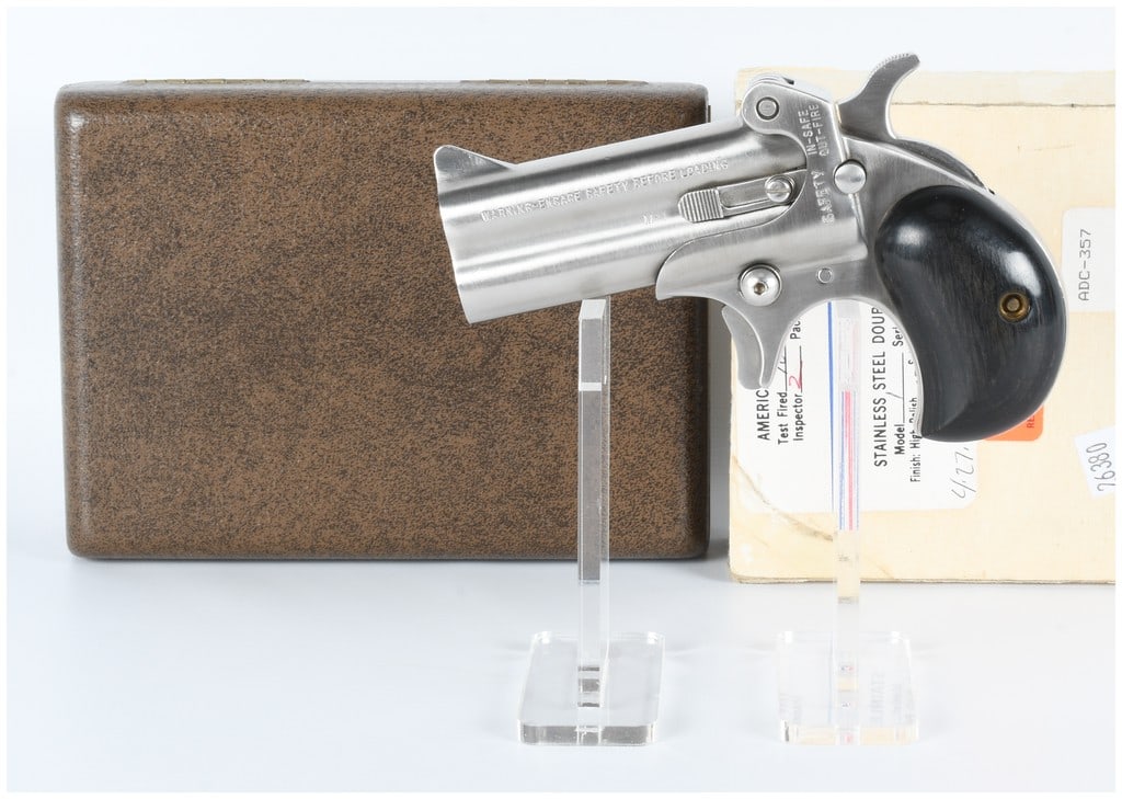 American Derringer Corp. M-1 .357 Mag Pistol with Case and Paperwork: A modern American Derringer Corp. M-1 double-barrel pistol, chambered in .357 Magnum. The firearm is crafted from stainless steel with a satin grey matte finish and fitted with dark wood-like grip pan