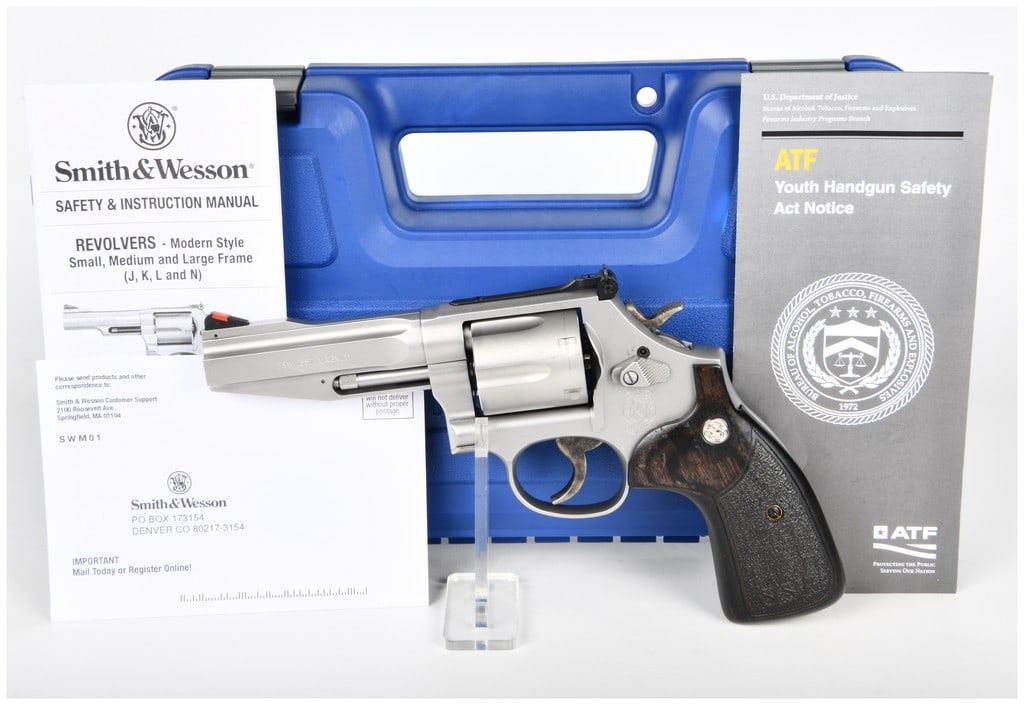 Smith & Wesson Model 686-6 SSR Pro Series .357 Mag Revolver: A modern Smith & Wesson Model 686-6 SSR Pro Series .357 Magnum double-action/single-action revolver. The firearm features a stainless steel finish with dark wood and textured black composite grips, ea