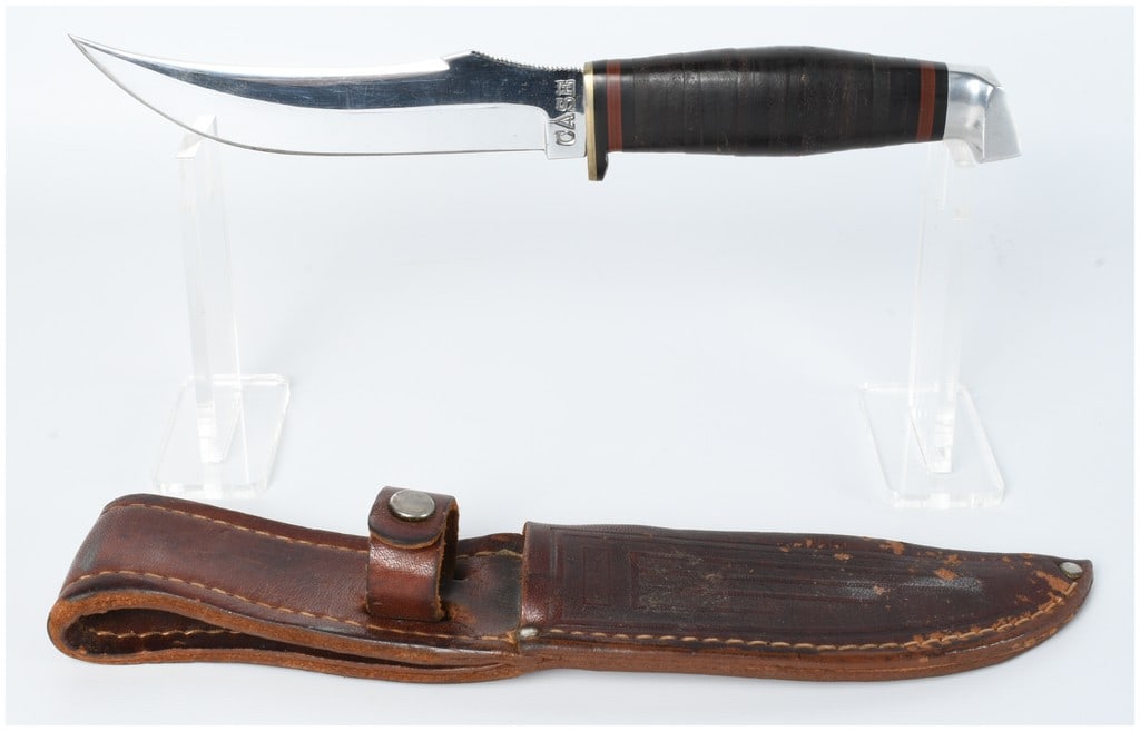 Case Fixed-Blade Hunting Knife with Leather Sheath: A fixed-blade hunting knife by Case, an English brand. The knife features a bright, polished metal blade, clearly marked "CASE" on the ricasso. It has a stacked dark leather handle flanked by metal (l