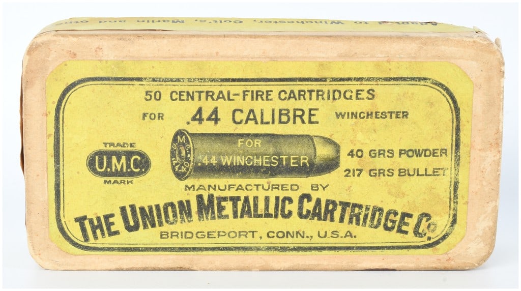 Union Metallic Ammo Co. (UMC) .44 Calibre Win Central-Fire Ammo 43 Live Rounds 4 Empties: An antique Union Metallic Cartridge Co. (UMC) cardboard box containing 43 live .44 Calibre Winchester Central-Fire cartridges and 4 empty casings. The box features faded and torn paper labels, primari