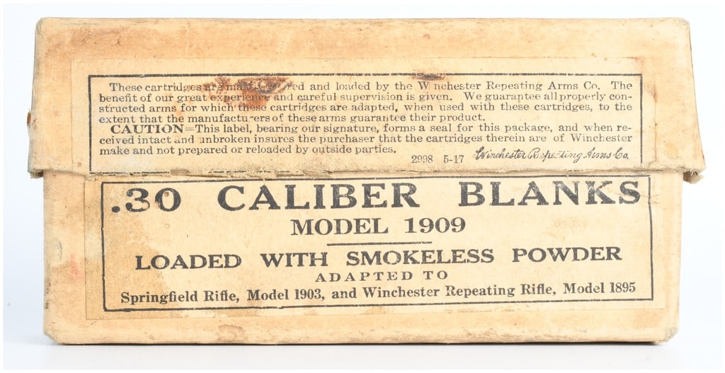 Win .30 Army Blank Smokeless Ammo Box with 19 Live Rounds: A vintage Winchester .30 Army Blank Smokeless Ammunition Box, partially open and containing 19 live brass rifle blank cartridges. The utilitarian cardboard packaging is typical for the early 20th cent