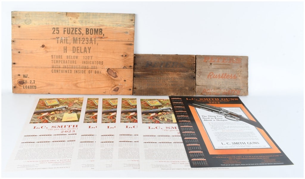 Vintage Military and Ammo Crate Panels with L.C. Smith Guns Ephemera: Three vintage wooden crate panels, comprising one large panel explicitly marked "25 FUZES, BOMB, TAIL, M123A1, H DELAY," with handling instructions, weight ("WGT. CU. 2.7 LOADED"), and storage directi