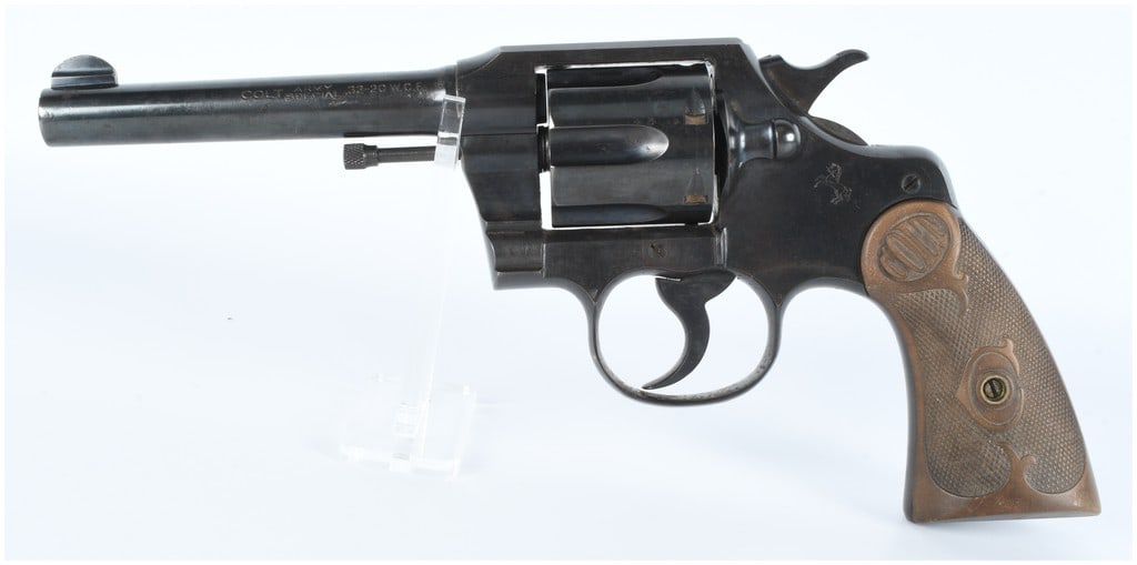 Colt Army Special .32-20 W.C.F. DA Revolver: A Colt Army Special .32-20 W.C.F. double-action revolver, constructed of blued steel, featuring a medium-length barrel and an exposed hammer. The grips are checkered dark brown composite, embossed wit