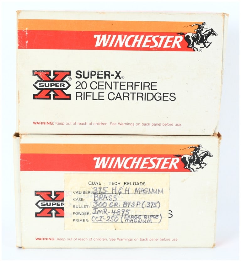 A Lot of 24 Winchester Super-X .375 H&H Magnum Rifle Cartridges and Two Empty Boxes: A lot consisting of 24 components of Winchester Super-X .375 H&H Magnum centerfire rifle ammunition, including loaded cartridges and empty brass cases, accompanied by two Winchester Super-X cardboard