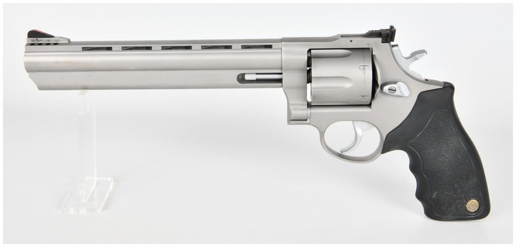 Taurus Raging Bull Model 44 Double-Action Revolver .44 Magnum (KJ295479): This is a large-frame, double-action/single-action revolver, identified as a Taurus Raging Bull Model 44. The serial number KJ295479 is clearly visible on the frame and barrel shroud. It is chambered