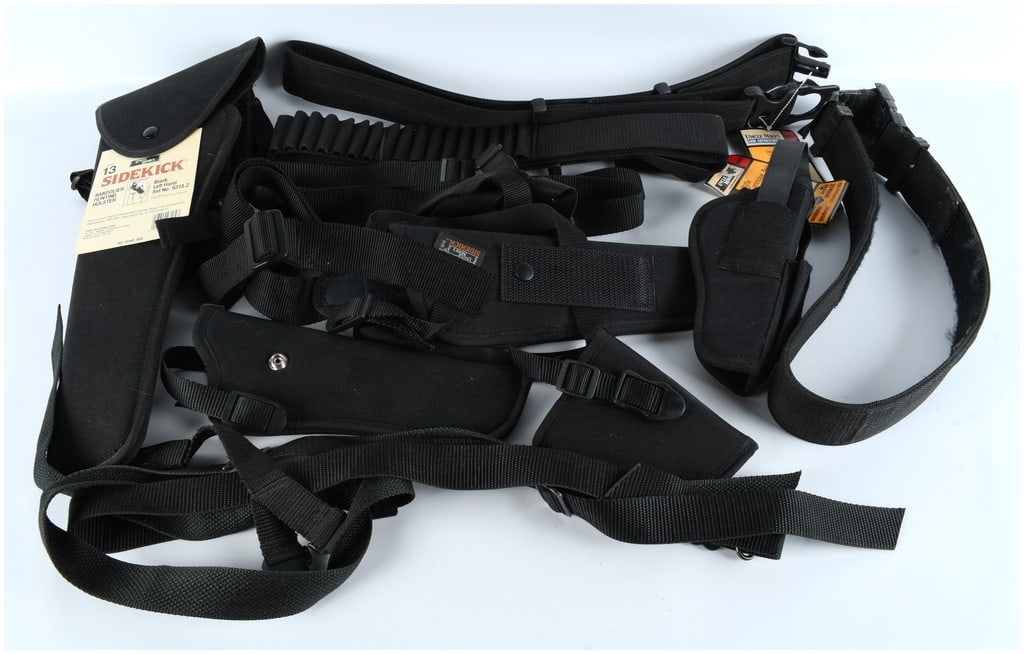 A Collection of 7 Uncle Mike's and Associated Nylon Holsters and Web Gear Accessories: A collection of 7 pieces of black synthetic web gear and nylon holsters, primarily manufactured by Uncle Mike's (Michaels of Oregon). This group of accessories includes various belts, holsters, and