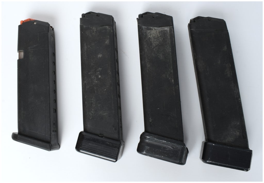 Glock Factory Magazine Lot .40 S&W Caliber A Group of Four: A group of four factory Glock detachable pistol magazines chambered for the .40 S&W caliber. These magazines are compatible with various Glock models, including the G22 and G23. All four magazines are