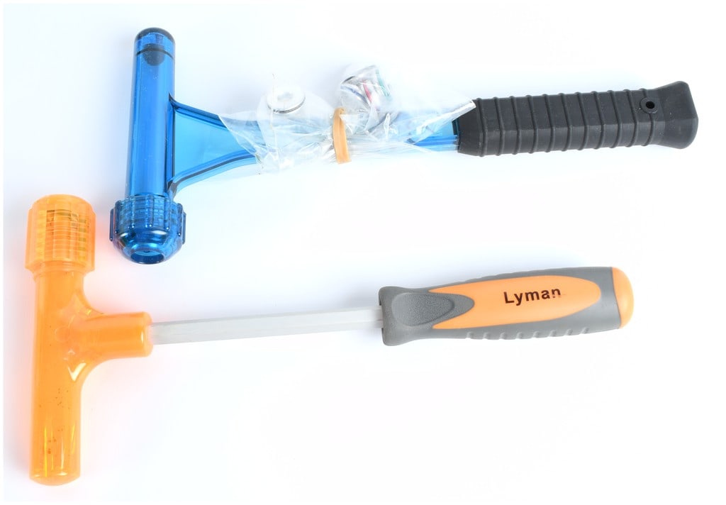 Lyman Magnum Inertia Bullet Puller and Related Reloading Tool (A Group of Two): The lot consists of two reloading and maintenance tools manufactured by Lyman. The primary item is identified through visual consensus as a Lyman Magnum Inertia Bullet Puller, featuring a translucent