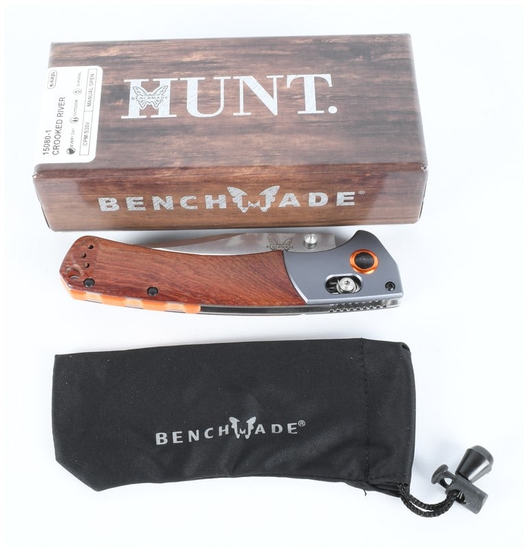 Benchmade 15080-1 Crooked River Folding Knife with Box and Pouch: This lot consists of three items: a Benchmade Model 15080-1 Crooked River manual-open folding knife, its original packaging box, and a branded fabric storage pouch. The knife features a drop-point bla