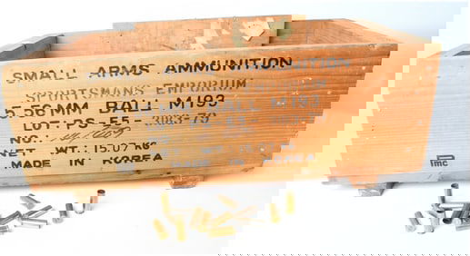 A Bulk Lot of Spent .38 Special Brass and Nickel Cartridge Casings in a PMC 5.56mm Ammunition Wood