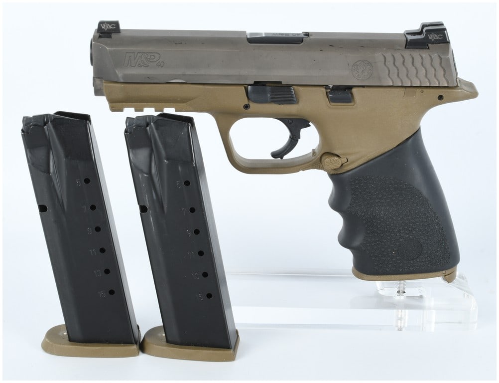 Smith & Wesson M&P 40 Semi-Automatic Pistol, Serial Number HAF7803: Smith & Wesson M&P 40 Semi-Automatic Pistol, Serial Number HAF7803. This modern polymer-framed pistol is chambered in .40 S&W. It features a distinctive two-tone configuration, consisting of a Tan/Fla