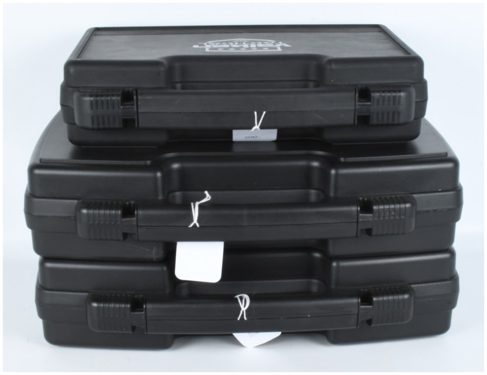 A Trio of Polymer Hard Storage Cases, Including One Valken Tactical Case: A trio of hard polymer storage cases designed for the secure transport or storage of handguns, equipment, or sensitive instruments. The lot consists of three identical black plastic cases, each featur