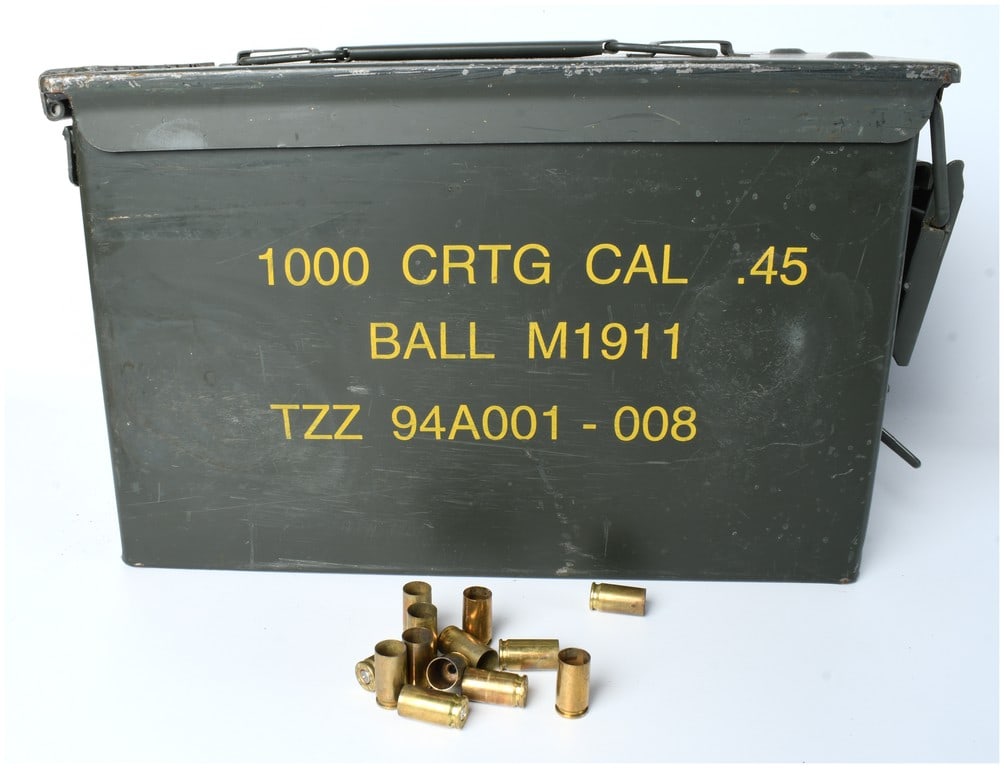 A Large Metal Ammo Can Stenciled for 1000 Rounds .45 BALL M1911 Containing Spent Brass Casings: This lot consists of a large metal ammo can, consistent with the M2A1 style military surplus container, stenciled with specific load data. The can is marked 1000 CRTG CAL .45 BALL M1911, indicating