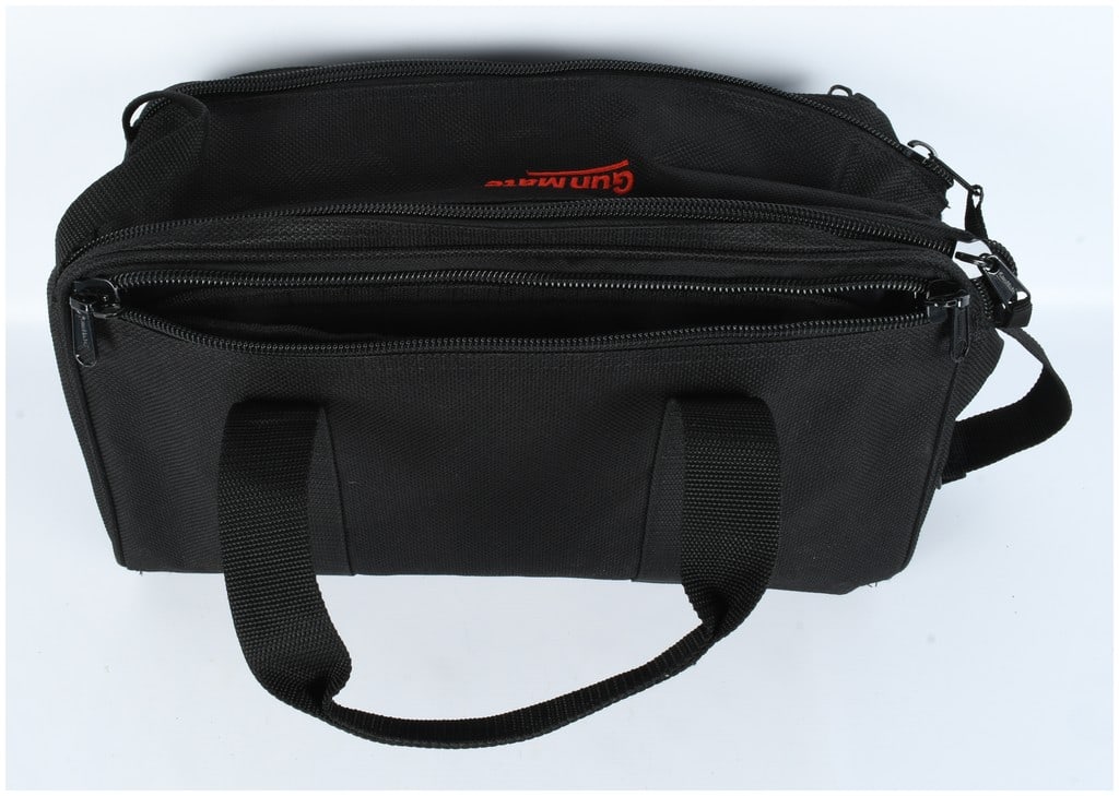 GunMate Black Multi-Compartment Range Bag: This is a single black synthetic textile carrying case, identified by the visible red branding inside the main compartment as a GunMate product. The case is configured as a multi-compartment range