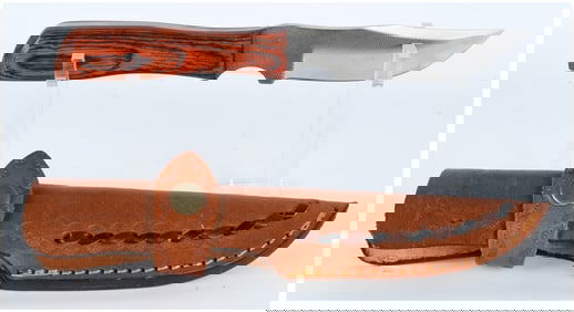 A Fixed Blade Knife with Serrated Spine and Custom Leather Sheath