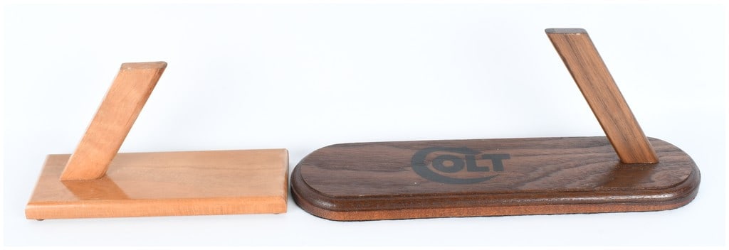 A Pair of Custom Handgun Display Stands for Colt 1911 and Luger 9mm: This lot comprises a pair of custom-made wooden handgun display stands designed for collector-grade presentation. The total quantity of items in this lot is 2. The first stand features a dark hardwood