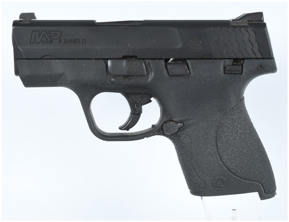 Smith & Wesson M&P 9 Shield Semi-Automatic Pistol 9MM (3.125 BBL) Serial JFE2458: A Smith & Wesson M&P 9 Shield semi-automatic pistol, serial number JFE2458, chambered in 9MM. This is a compact, striker-fired pistol featuring a black matte finish on the slide and a black textured p