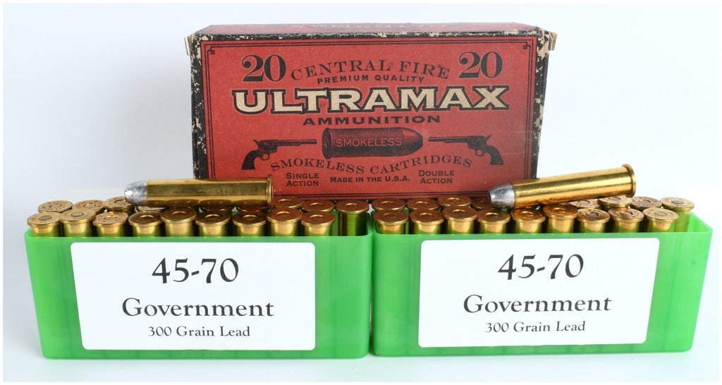 A Lot of 59 .45-70 Government Centerfire Ammunition Cartridges: A lot consisting of 59 rounds of .45-70 Government centerfire ammunition. The lot includes two modern green plastic hinged ammunition boxes and one vintage-style cardboard box of Ultra Max Ammunition.