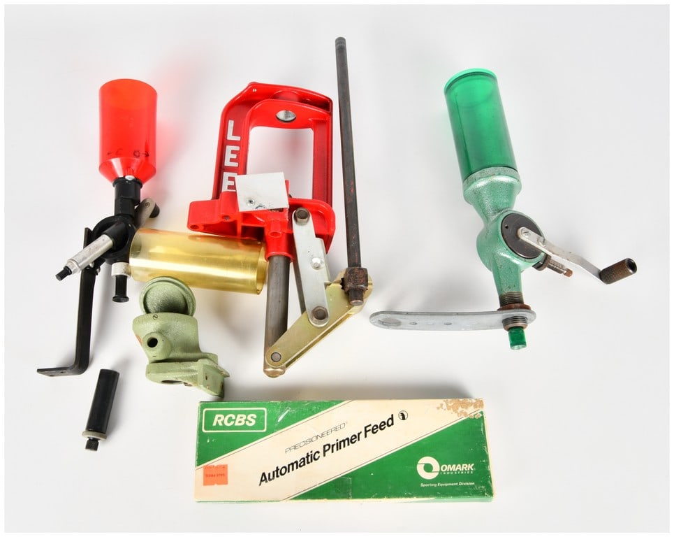 A Collection of 7 Lee, RCBS, and Redding Ammunition Reloading Tools and Components: This lot comprises a collection of seven distinct assemblies and components used for the manual reloading of metallic ammunition cartridges. The centerpiece is a red painted cast metal C-frame single-