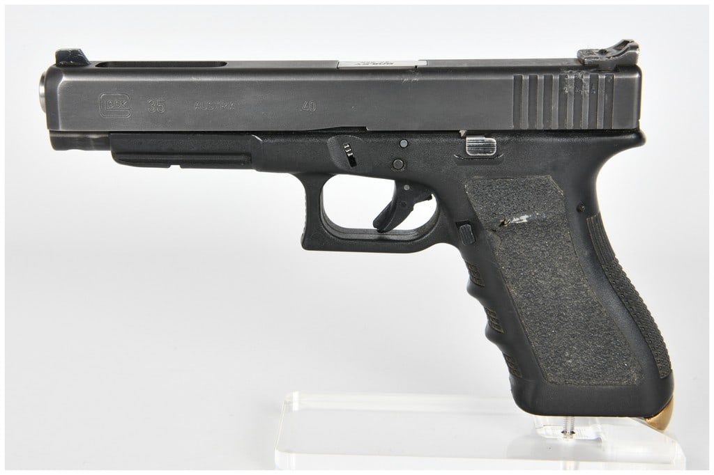 Glock Model 35 Semi-Automatic Pistol .40 S&W Serial Number DBD990US: A customized Glock Model 35 semi-automatic pistol chambered in .40 S&W. This is a long-slide pistol featuring a black polymer frame and a black finished slide. The pistol has been heavily modified for