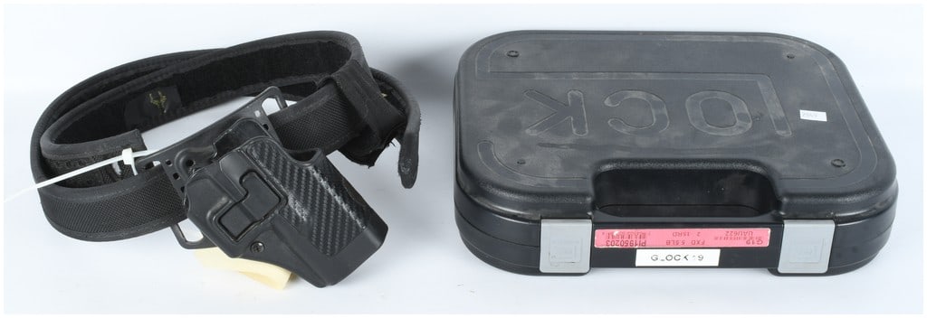 Collection of Glock 19 Pistol Accessories including Factory Case Holster and Muzzle Compensator: A comprehensive collection of accessories and storage materials intended for the Glock 19 semi-automatic pistol, 9mm caliber. This lot contains NO actual firearm or ammunition. The primary component i