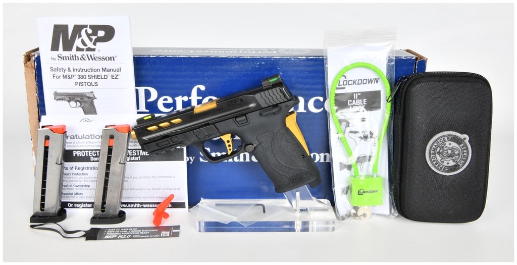 Smith & Wesson Performance Center M&P 380 Shield EZ M2.0 Pistol with Gold Accents, c. 2020: A Smith & Wesson Performance Center M&P 380 Shield EZ M2.0 semi-automatic pistol chambered in .380 Auto. This firearm features a black polymer frame and a black steel slide accented by a gold-tone fin