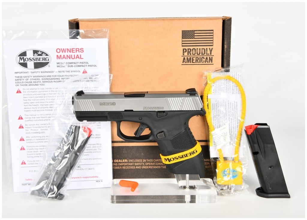 Mossberg MC2c Compact 9mm Luger Semi-Automatic Pistol, Stainless Slide, 2022: This auction lot features a Mossberg MC2c compact semi-automatic pistol chambered in 9mm Luger. The firearm is constructed with a matte stainless steel slide featuring aggressive front and rear cockin