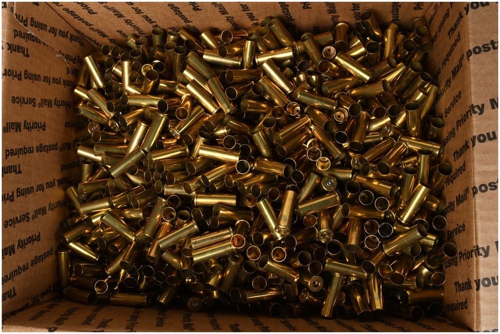 11 Lbs of Empty .38 SPL Brass Ammunition Casings: A collection of empty .38 SPL brass ammunition casings. This assortment consists of once-fired brass components primarily of .38 Special caliber, as evidenced by visible headstamps from manufacturers