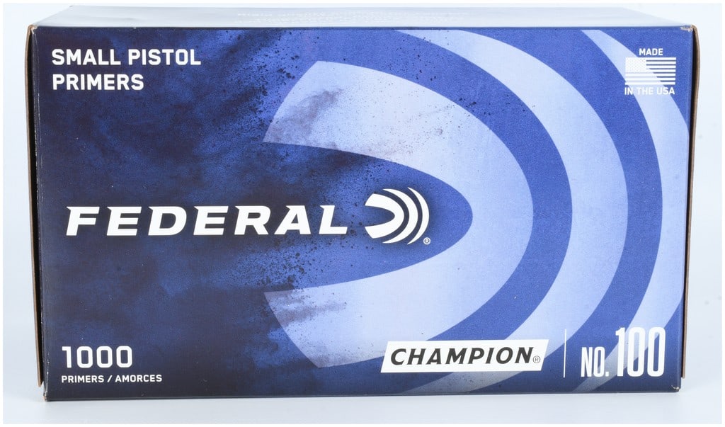 1000 Federal Champion No. 100 Small Pistol Primers: A lot of 1000 Federal Champion No. 100 small pistol primers. The items are presented in their original blue and white cardboard packaging, which is marked with the Federal brand logo and the Champion