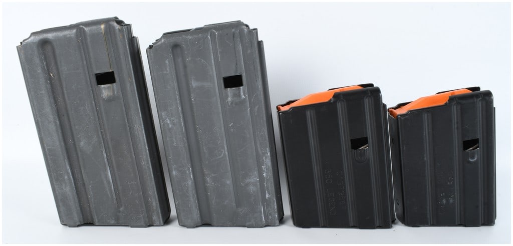 4 AR-15 Magazines Including Colt and DuraMag Examples: This lot consists of 4 magazines designed for the AR-15 platform. The collection includes two gray metal magazines and two black stainless steel magazines. The gray magazines are chambered for 5.56mm